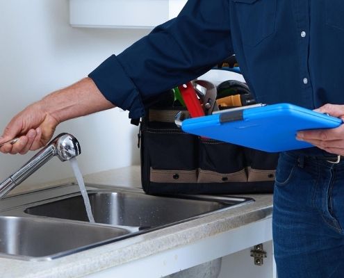 inspector checking the water from a faucet